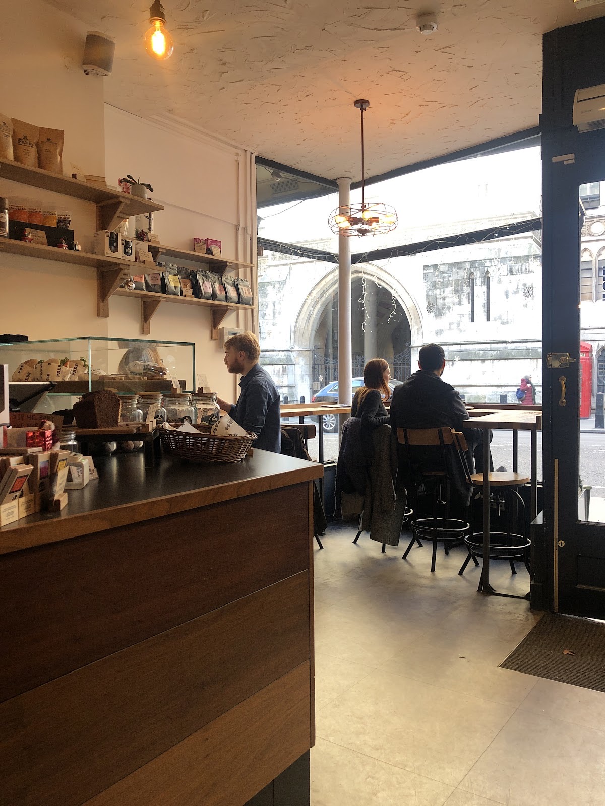 Interior looking toward the bright shopfront window with the counter in front