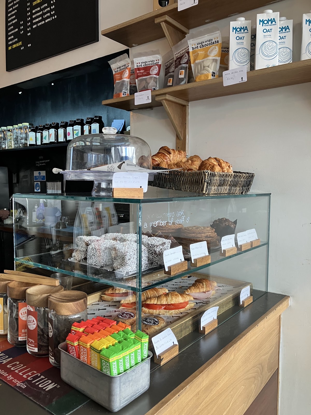 Glass pastry cabinet full of cakes, tarts and traybakes